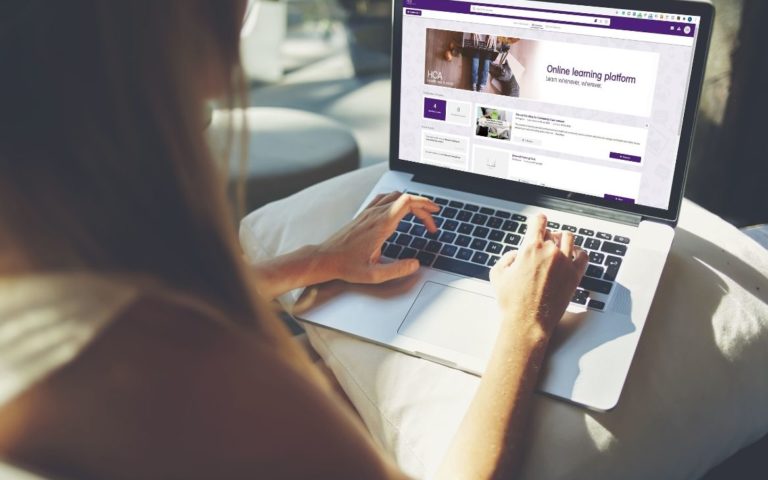 aged care worker using a laptop to complete an online course