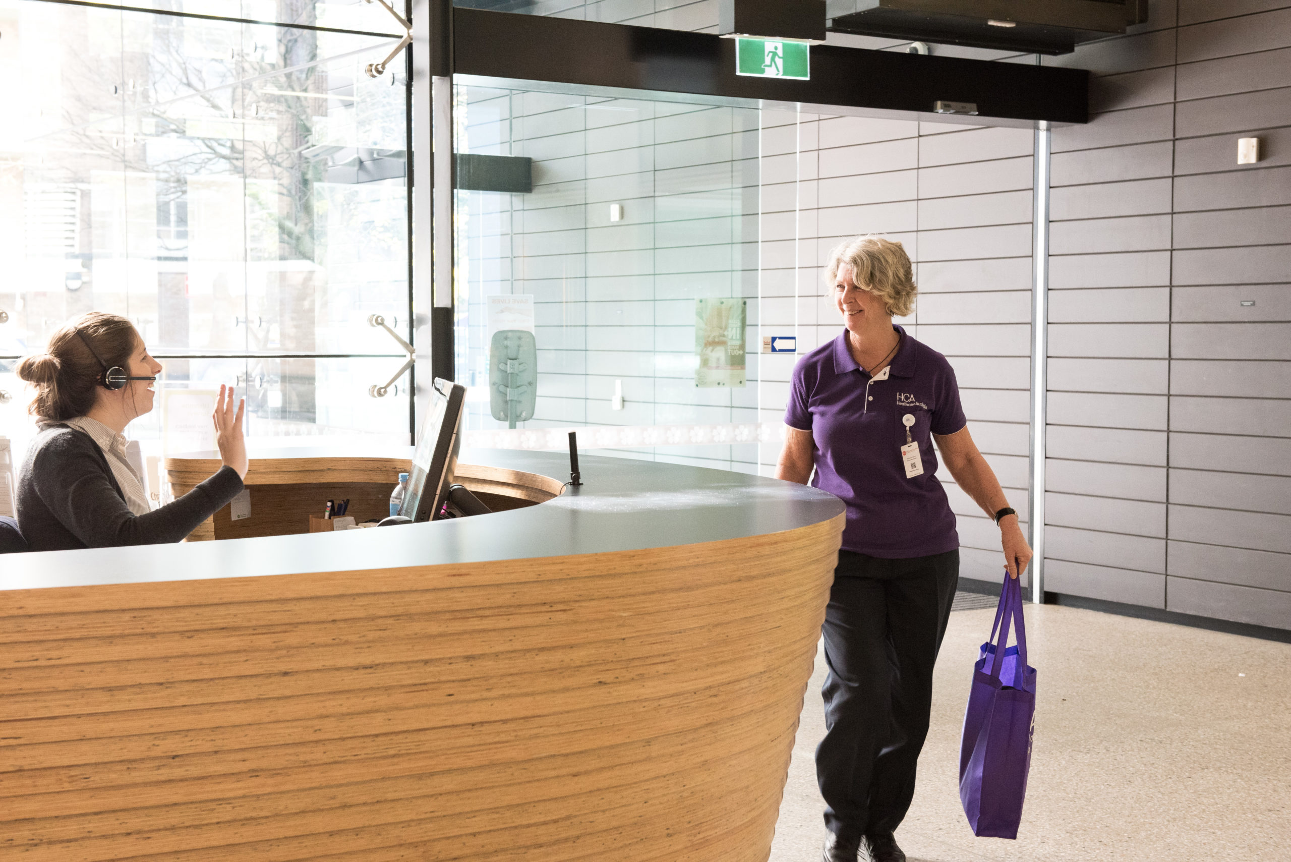 HCa nurse walking into work holding a HCA purple bag 1 scaled - Healthcare Australia